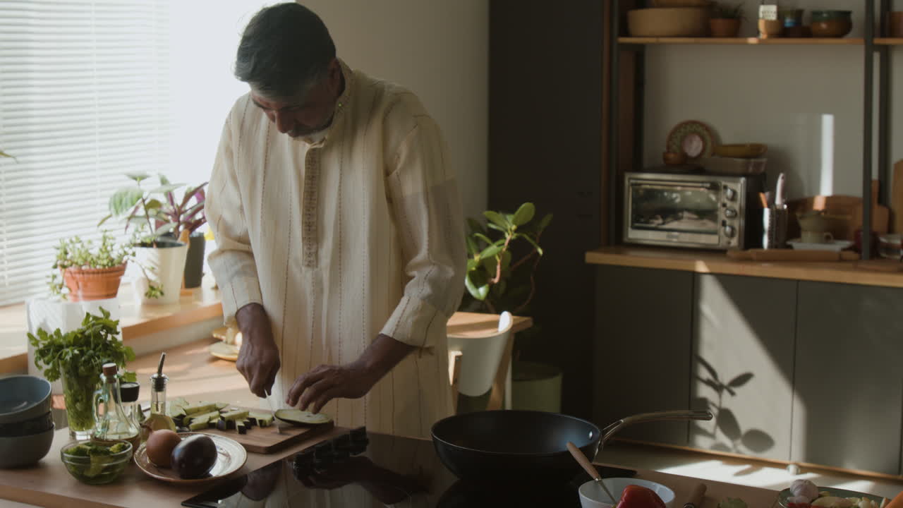Indian Man Cooking in his Kitchen