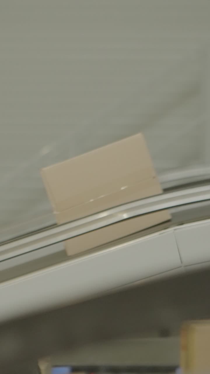 Box moving on conveyer belt in an industrial setting, efficient transport