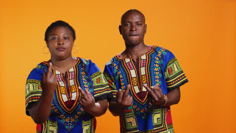 provocative ethnic couple show middle finger on camera