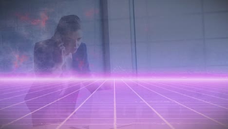 Animation-of-illuminated-grid-pattern-over-caucasian-businesswoman-talking-on-cellphone-at-office