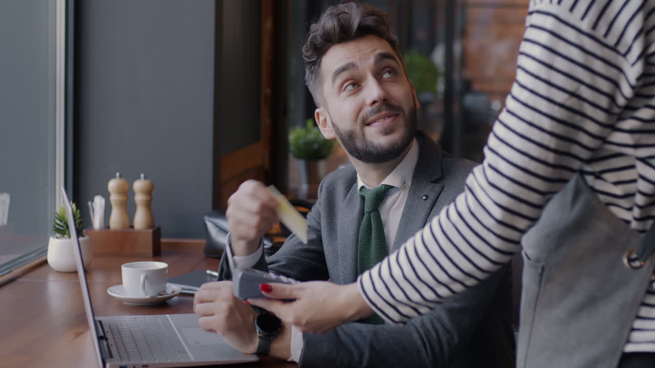 Businessman Paying at a Restaurant