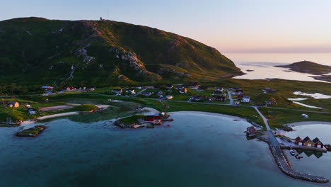 aerial tracking shot of traditional norwegian homes on the coast of north norway