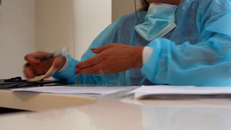 female doctor writing about the works done with a patient