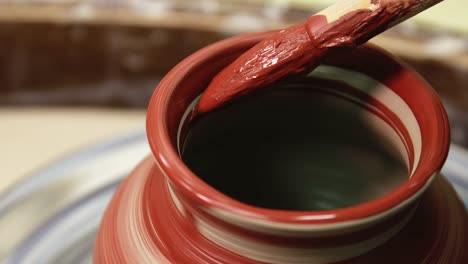 rotating pottery wheel. craftsman artist painting pot