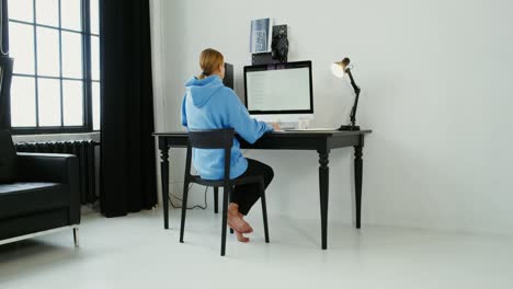 woman working on computer at home office