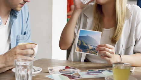 mixed race group young people meeting cafe showing photographs