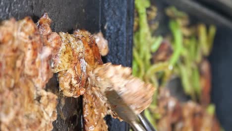 cooking meat and vegetables on a griddle