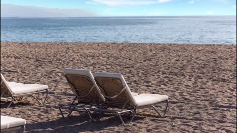 beach lounge chairs with calm sea