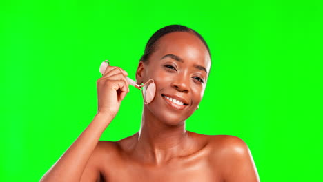 Black-woman,-beauty-and-facial-roller-on-a-green
