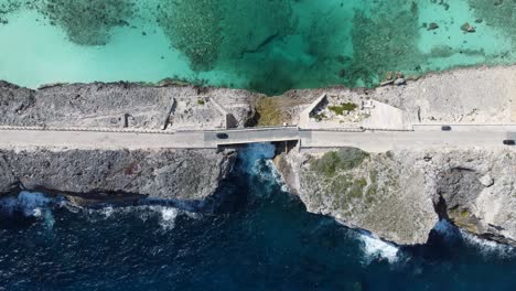 cinematic aerial wide still view top down drone shot of glass window bridge on the island of eleuthera in the bahamas - separating the atlantic ocean from the caribbean sea