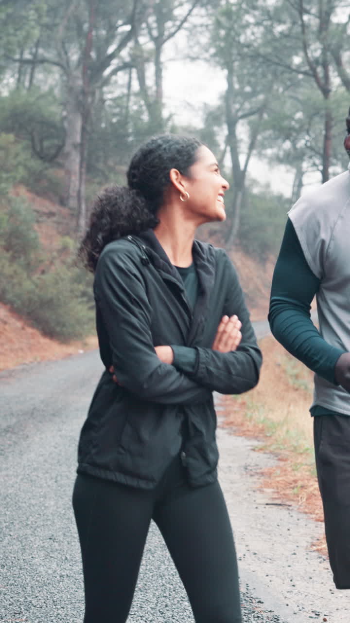 Happy Couple Walking and Laughing on a Forest Road