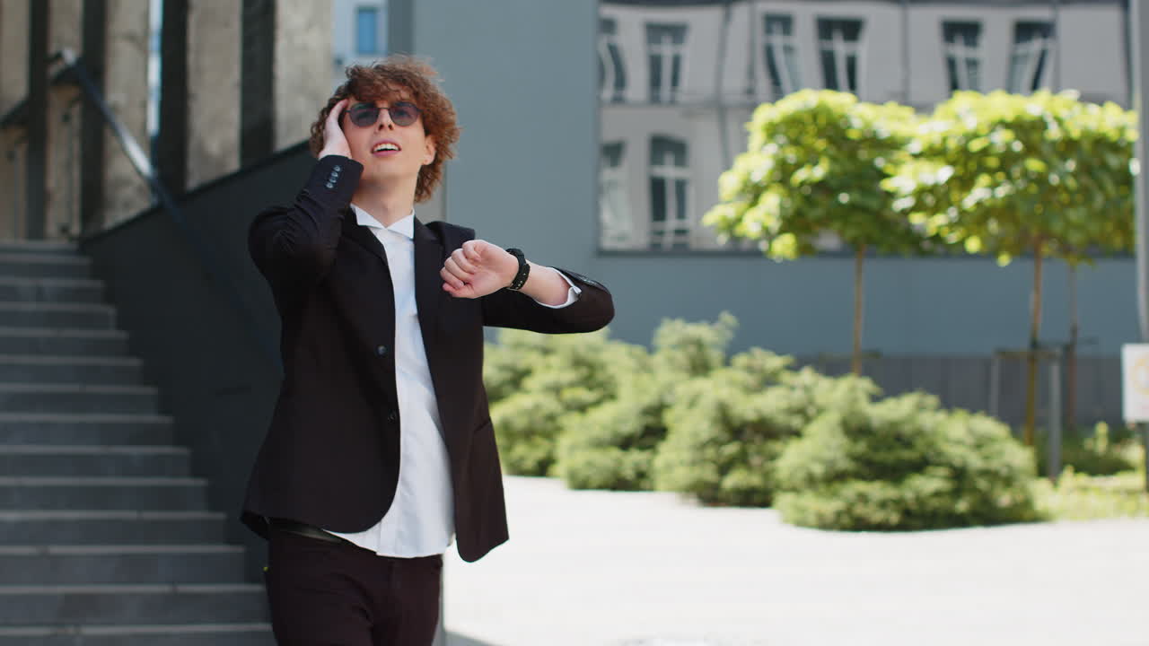 Businessman check time looking at wrist watch shock lateness hurry go faster quickly walking in city