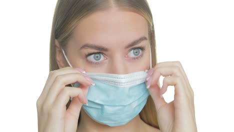 frustrated woman adjusts her uncomfortable mask, close-up