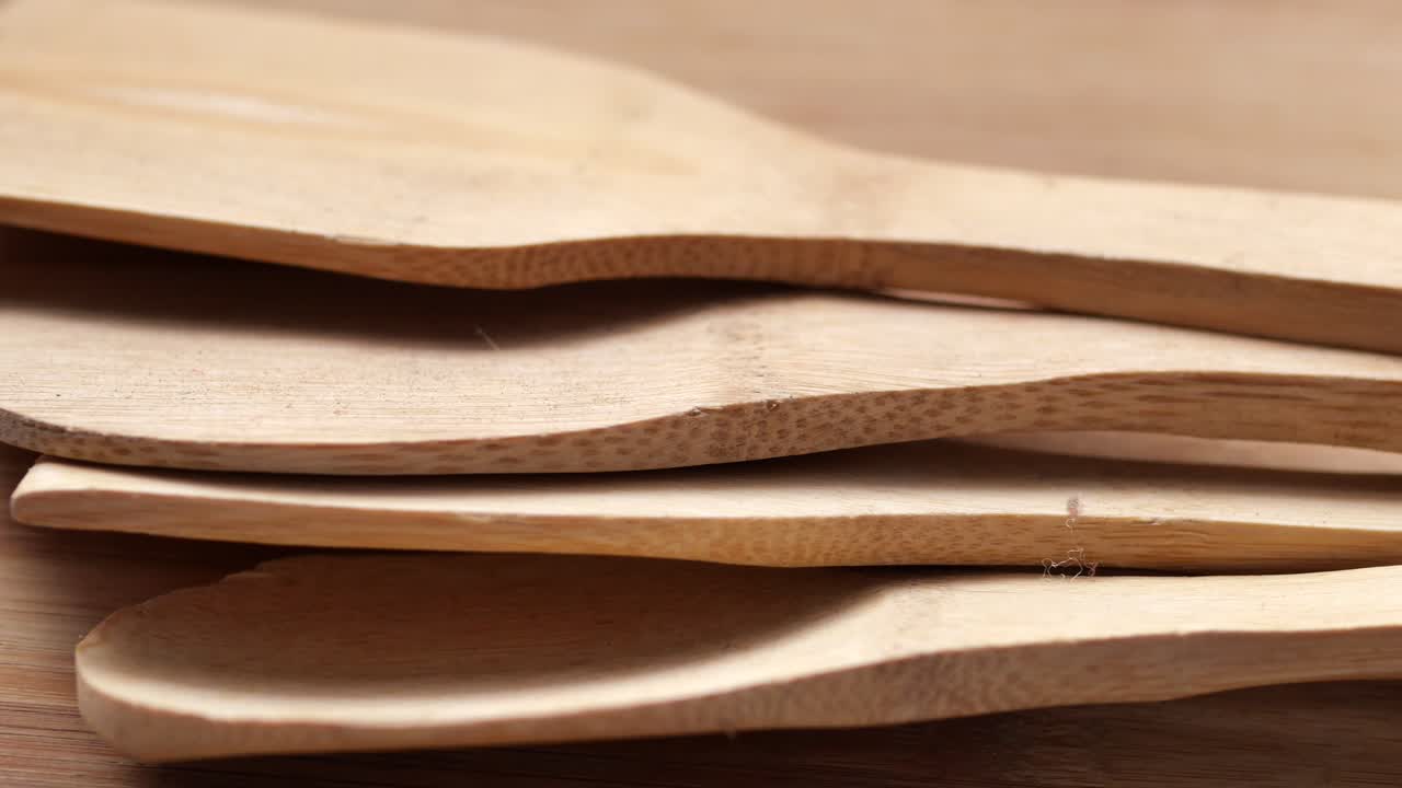 Wooden cutlery fork and spoon on a chopping board on table ,