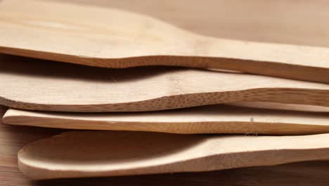 Wooden-cutlery-fork-and-spoon-on-a-chopping-board-on-table-,