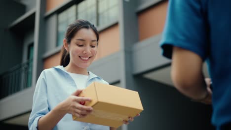 young woman signing electronic signature on tablet for agreement of contract digital receiving parcel from blue delivery man from shopping online. courier man delivering package to destination.