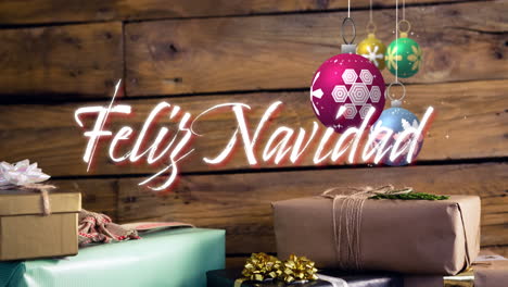 animation of feliz navidad text and christmas bauble on wooden background