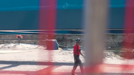 bridge construction rigging with worker in red jacket at sunny site in south of france