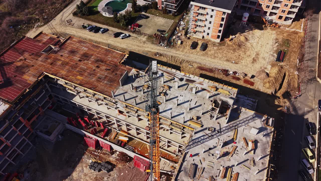 Aerial View of a Large Building Construction Site with Crane