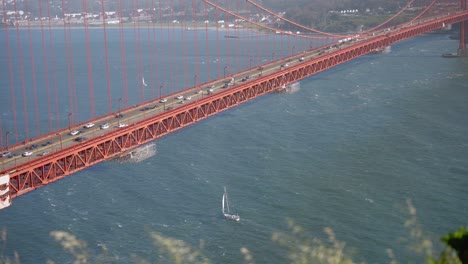 closeup of the golden gate bridge and cars passing by