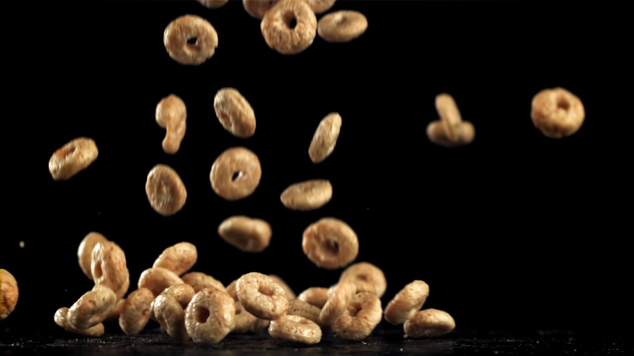 Cereal Rings Falling in Slow Motion onto a Black Surface