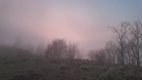 Misty-sunrise-over-hills-with-radio-tower-in-Genoa,-vibrant-sky-colors