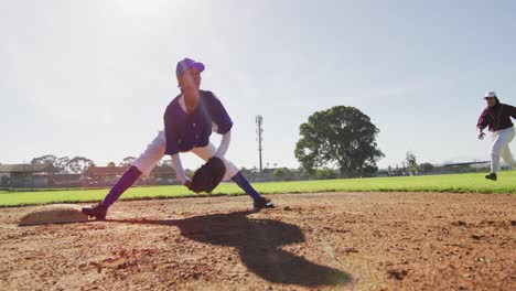 Diverse-female-baseball-players,-fielder-on-base-catching-out-a-running-hitter-on-baseball-field