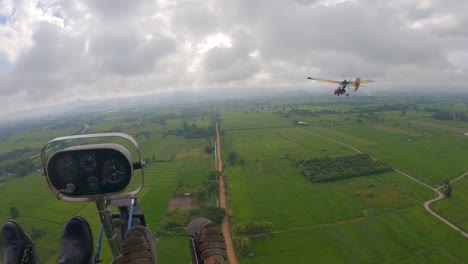 pov from ultralight plane cockpit with another plane flying infront