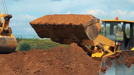 wheel loader and excavator working on construction site. heavy machinery