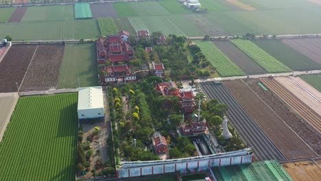 aerial drone flyover chifa matsu temple complex in the middle of agricultural fields, a sacred site dedicated to goddess of sea, a blend of cultural heritage and rural landscape, yunlin, taiwan