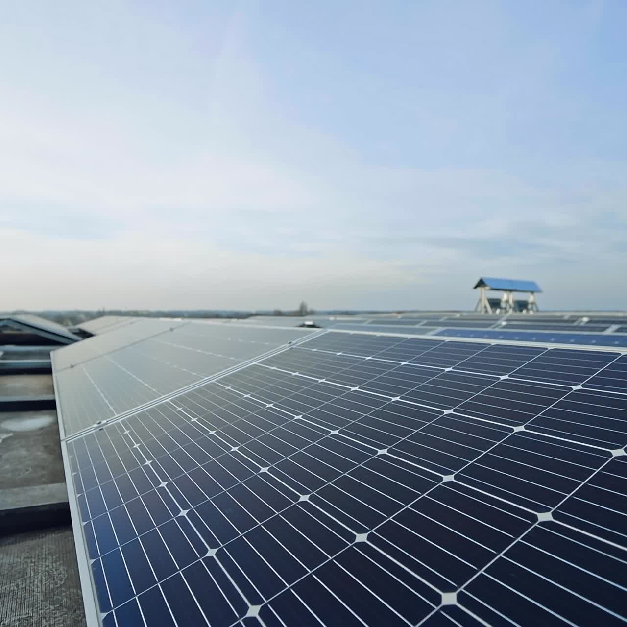 Solar panels in rows under the blue sky. Photovoltaic panels in sunlight. Alternative source of energy. Innovative solar plant.