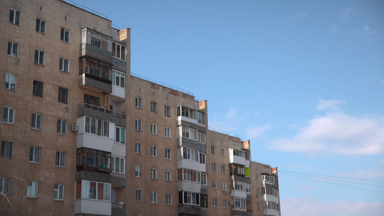 Old Concrete Apartment Block Blue Sky, Balconies With Enclosed Glazing, Weathered Plaster Facade, Soft Morning . Media