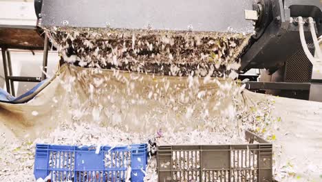 Close-up-shot-of-shredded-paper-overflowing-containers-in-a-waste-recycling-plant