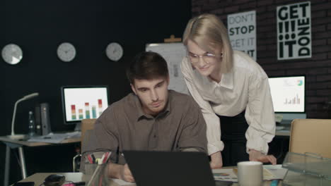 satisfied woman boss praising employee for good work in dark office