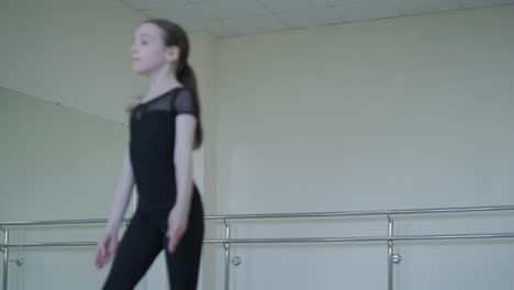 young ballerina practicing dance moves in studio