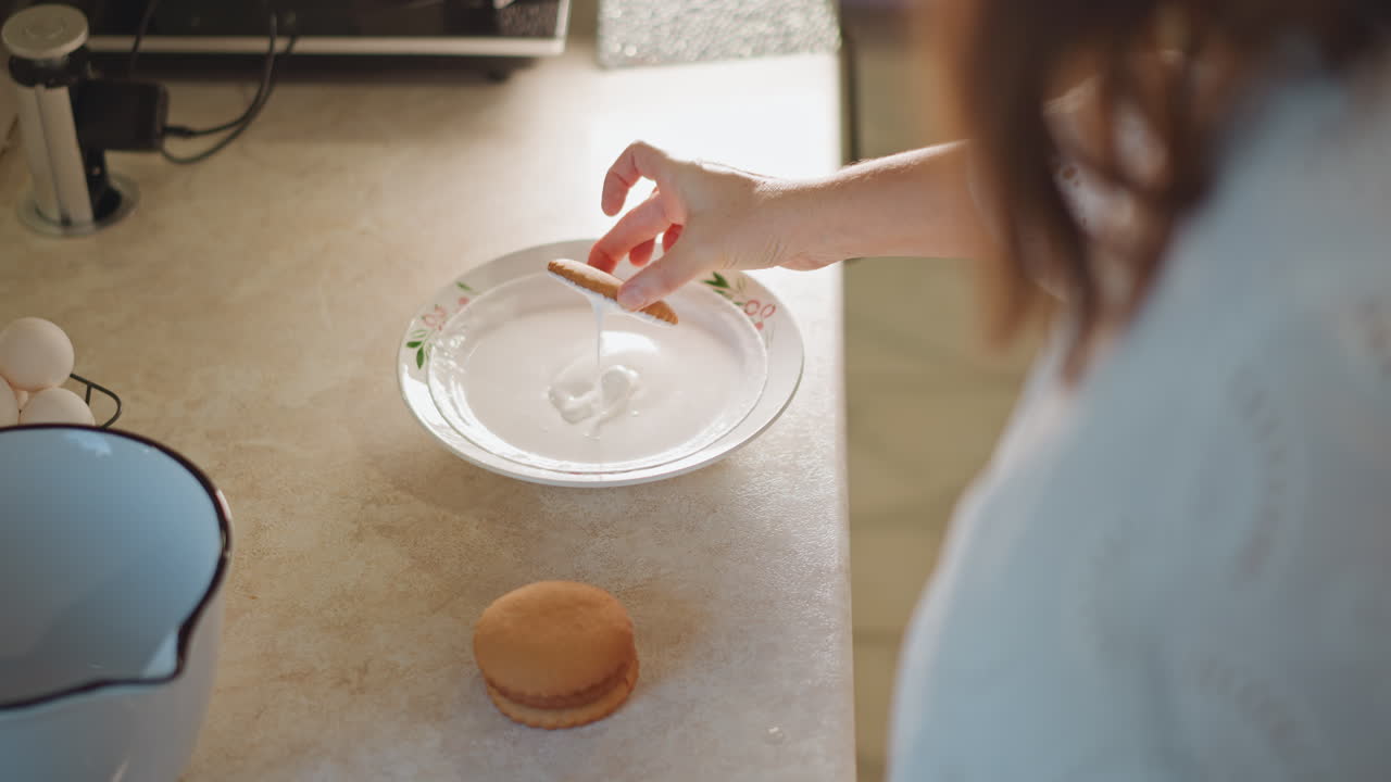 Woman placing filling into pie shell on glass plate eggs carton in hand neat pie base on countertop enamel jug beside methodical portioning home pastry routine warm morning light closeup