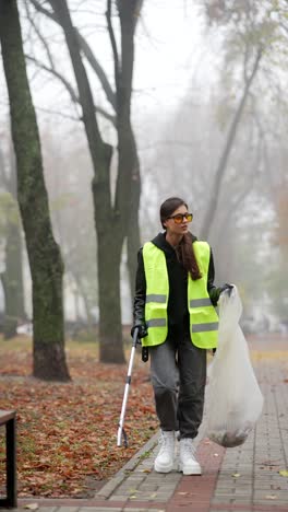 woman cleaning up litter in a park