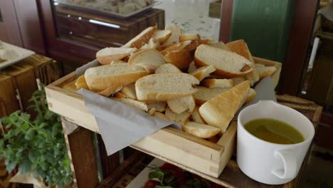 A-rustic-table-made-from-a-wooden-crate,-on-which-there-are-slices-of-bread