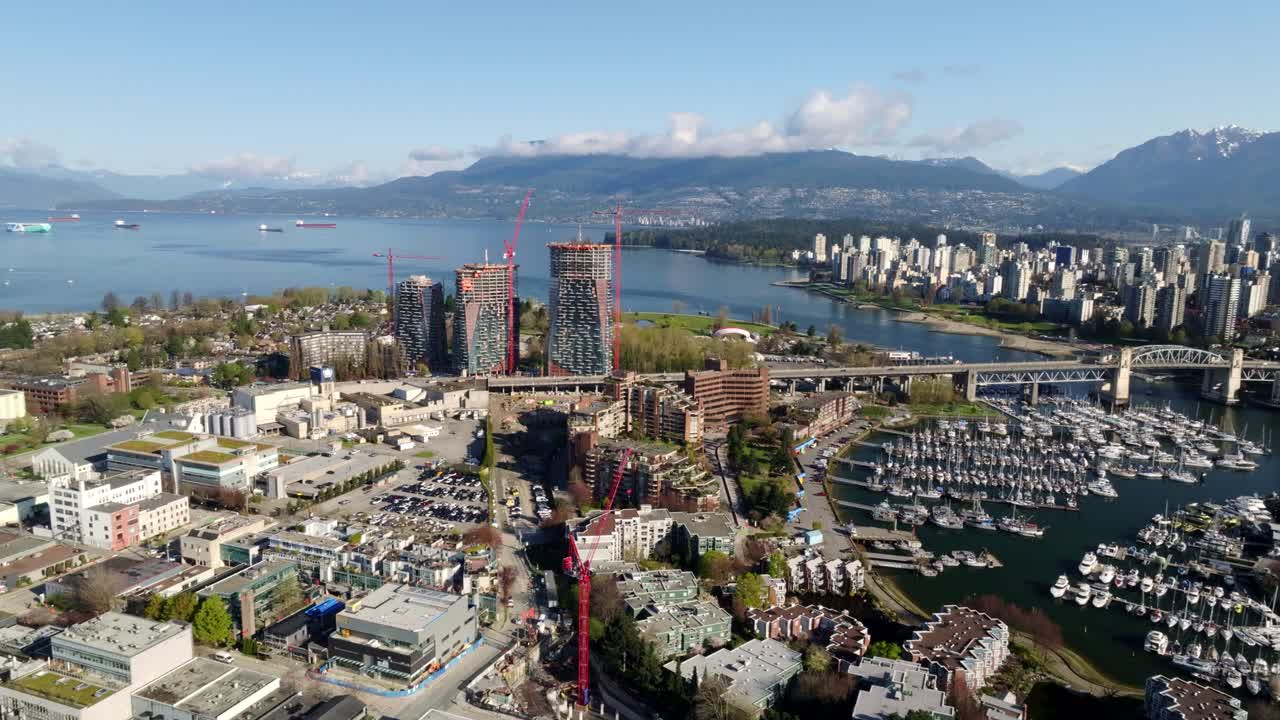 A Stunning View Captures Modern High-rises, a Bustling Marina, and Scenic Mountains by the Water in Vancouver, British Columbia, Canada - Wide Shot