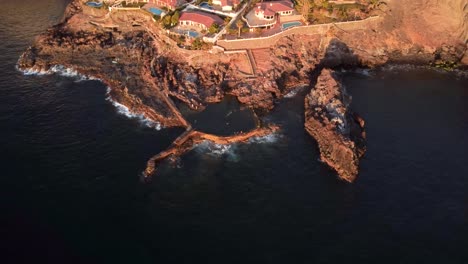 view of coastal town next to the sea drone aerial bird view, puerto de santiago, los gigantes, tenerife, canary islands, spain