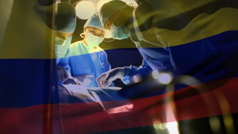 Animation-of-flag-of-colombia-waving-over-surgeons-in-operating-theatre