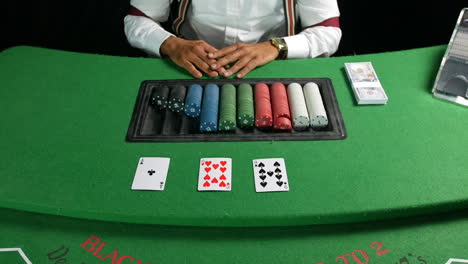 croupier dealer dealing cards at a poker game in a casino