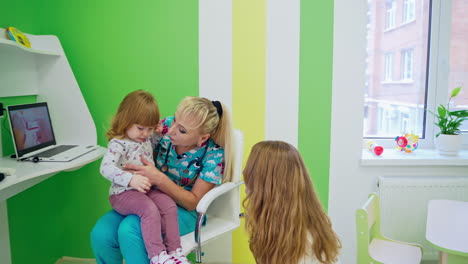 little girl visiting doctor. doctor examining child girl in hospital