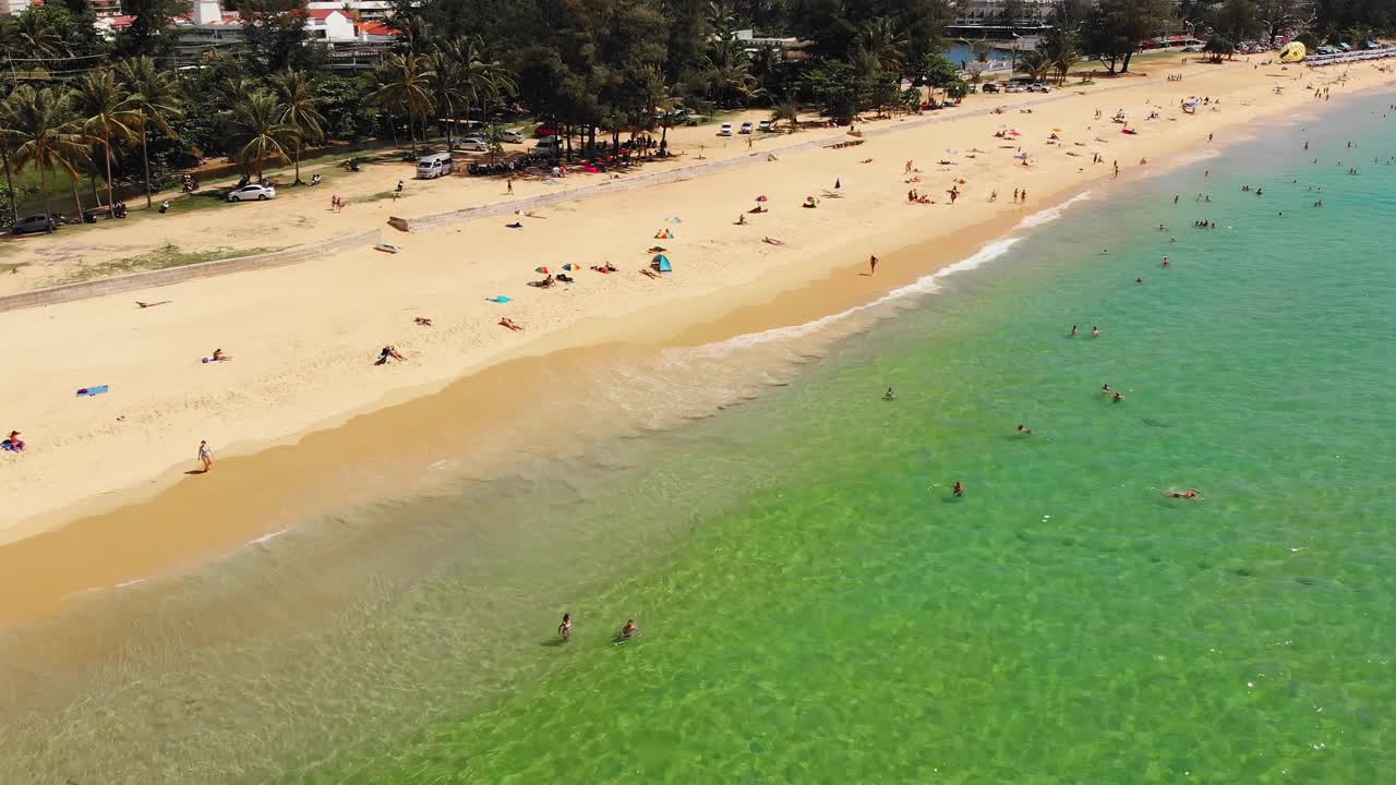 Aerial coastline drone shot of people at Phuket island beach, Thailand