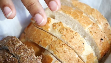 close up of a sliced loaf of bread with sesame seeds