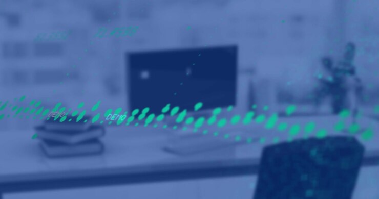 Glowing green ripple emerging sweeping across desk into monitor showing numeric data then fading