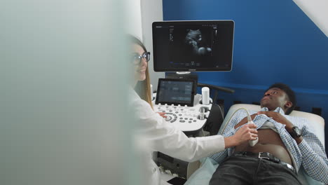 doctor performing ultrasound on patient
