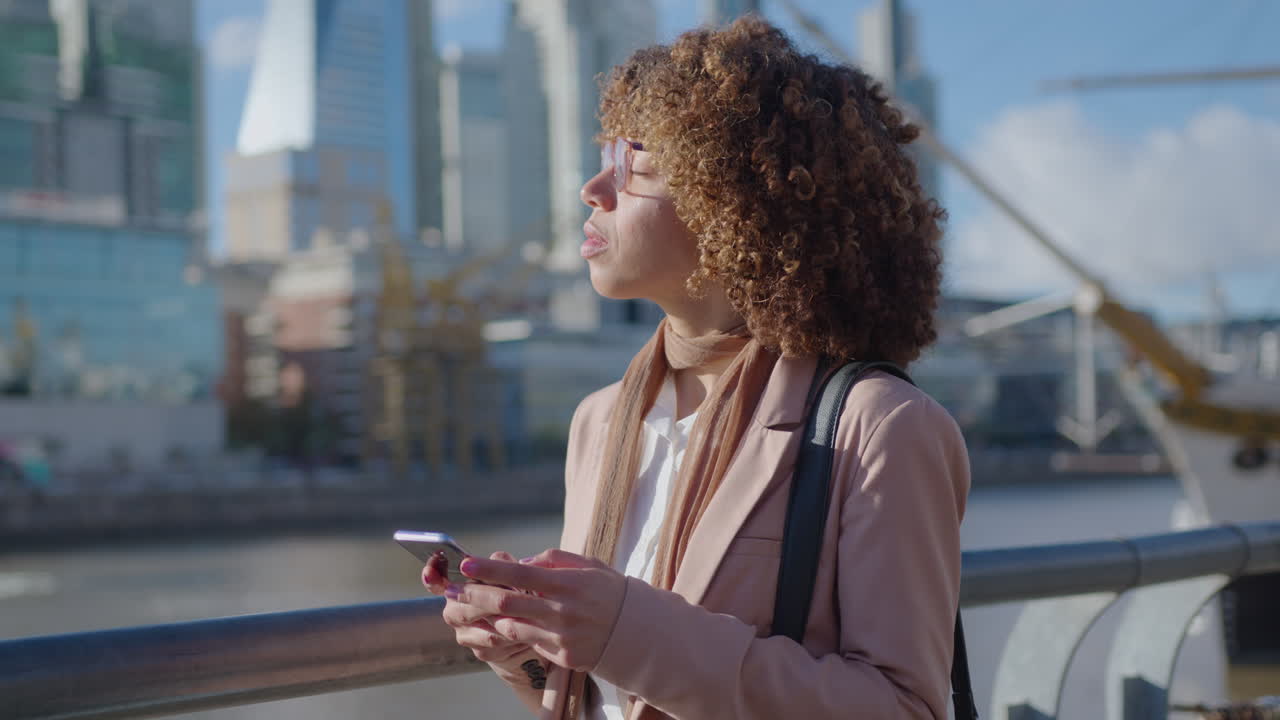 Black Businesswoman Standing in Downtown and Using Smartphone