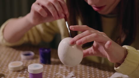 child painting an easter egg