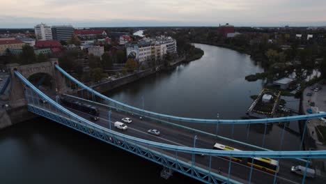 vehicles transportation over grunwald bridge in wroclaw at sunset